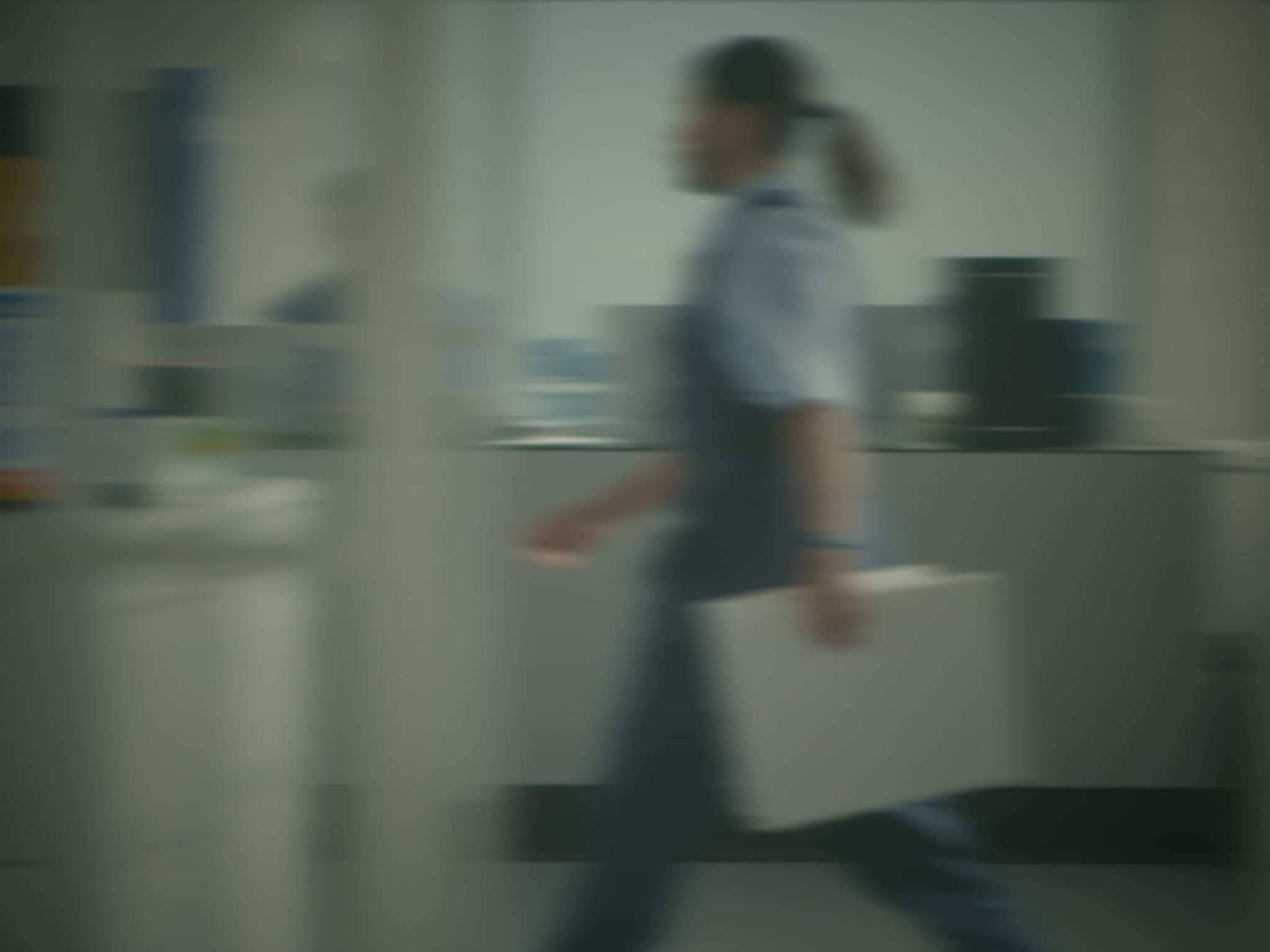 A caseworker carrying a file through a government program office